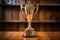 shiny athletic trophy sitting on a wood table