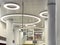 Shiny beautiful shining expensive white high-tech futuristic ceiling with round neon lamps