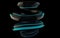 Shiny black abstract spiral form with blue glowing stripes