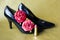 Shiny black stiletto pointed heeled shoes.