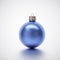 Shiny blue crimson Christmas bauble on light grey