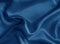 Shiny blue crumpled fabric. Wavy cloth background