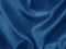 Shiny blue crumpled fabric. Wavy cloth background