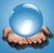 Shiny Blue Crystal Ball in Hands