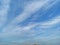 Shiny blue sky with white clouds and mountains