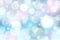 Shiny bokeh on soft tone rainbow background. Galaxy holographic fantasy backdrop. Trendy blurred delicate pastel blue