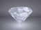 Shiny brilliant diamond placed on gray background