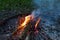 Shiny burning fire in the dark shows the romantic side of a campfire or bonfire, fire safety and the need of a fire insurance