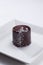Shiny chocolate cake with silver dots