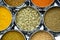 Shiny Circular Silver Bowls of Indian Spices and Seeds