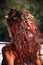 Shiny curly woman reddish hair with autumn leaves on autumn sun