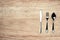 Shiny cutlery on wooden background top view shot