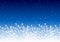 Shiny fireworks border on blue starry sky - horizontal background for Christmas and New Year holiday design