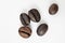 Shiny freshly roasted coffee beans on a white background. Isolated