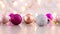 Shiny glitter pink gold and silver Christmas ornaments and blinking lights behind