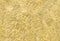 Shiny gold foil background with pattern. Yellow metallic texture with reflection