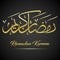Shiny gold Ramadan kareem calligraphy on black background