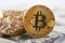 Shiny golden bitcoin and gold lump put on dollar banknote and represent new financial trends