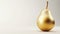 Shiny golden pear made of gold on white background, perfect for opulent decor themes, advertisements, and artistic