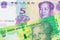 A shiny, green 10 rand bill from South Africa paired with a purple, blue and white five yuan bank note from China.