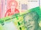 A shiny, green 10 rand bill from South Africa paired with a red and white one lev bank note from Bulgaria.