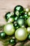 Shiny green christmas baubles closeup macro and tree