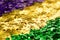 Shiny green, purple and golden glittering background for Mardi Gras holiday