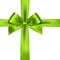 Shiny green satin ribbon on white background