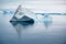 Shiny iceberg floating in calm water on foggy morning in Antarctica. Typical misty day in Antarctica.