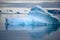 Shiny iceberg floating in calm water on foggy morning in Antarctica. Typical misty day in Antarctica.