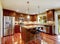 Shiny kitchen room with granite tops and steel appliances