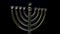 A shiny menorah spins and glimmers in the soft light.