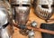 Shiny metal helmets of medieval knights with traditional weapons at a middle age theme festival