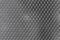 Shiny metal mesh dark background close-up