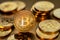 Shiny physical bitcoins on golden background. Blockchain technology.