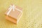 Shiny pink square gift box on gold background with stars