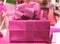 Shiny Pink Square Shaped Gift Box with Gritter Pink Ribbon Bow, Front View with Selective Focus