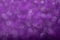 Shiny purple defocused glitter background.