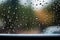 Shiny raindrops splashes falling cascading down wet glossy foggy glass window car outdoor during rainy stormy day