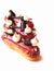 Shiny red glazed raspberry eclairs with meringues and chocolate decorations on white background