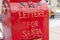 Shiny red mailbox for children to mail letters to Santa Claus