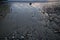 Shiny sand and gravel of beach and rippling sea in early morning light