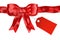 Shiny satin red ribbon with gift tag isolated on white