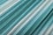 Shiny seagreen textile background, turquoise pleated cloth as creative backdrop,   blue beautiful  bright material,  turquise