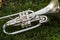 Shiny silver marching baritone instrument resting on the field d