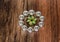 shiny silver metallic bracelet with beautiful small broach in the middle isolated on old vintage hardwood