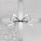 Shiny silver satin ribbon bow on argent