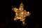 Shiny star made of electric garland as a Christmas decoration isolated on black