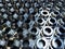 Shiny steel parts background. Regular industrial metal production pattern with selective focus