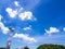 Shiny steel smokestack and cloud in sky